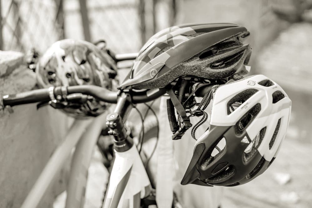 A helmet, gloves and cycling accessories arranged on a flat surface