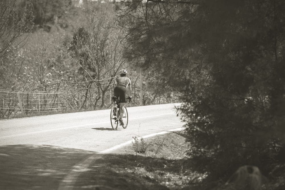 A road cyclist riding a quiet rural road